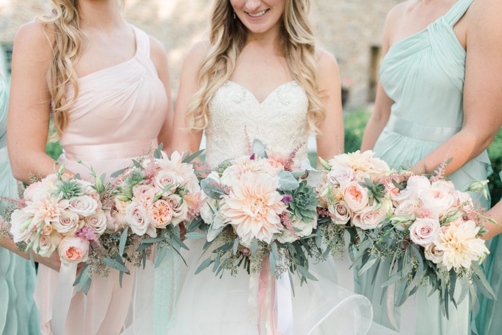 Blush and peach wedding bouquets with succulents at Stone Manor Country Club