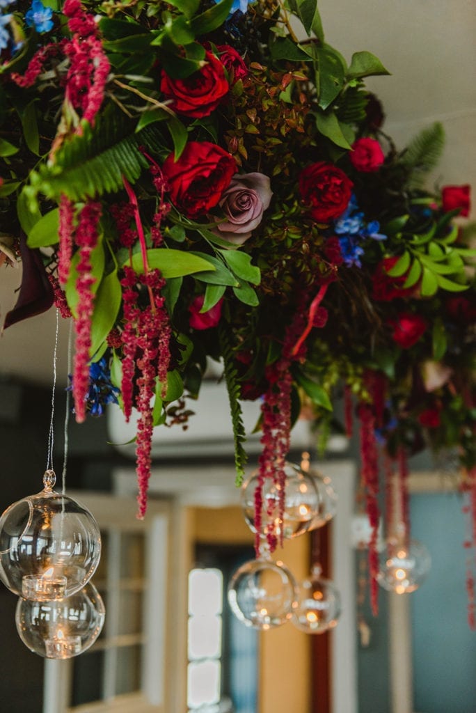 floral chandelier with hanging flowers and hanging votive candles