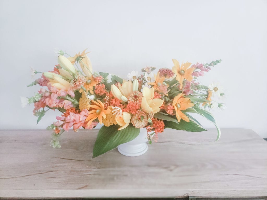 orange and yellow floral arrangement with all local maryland grown flowers