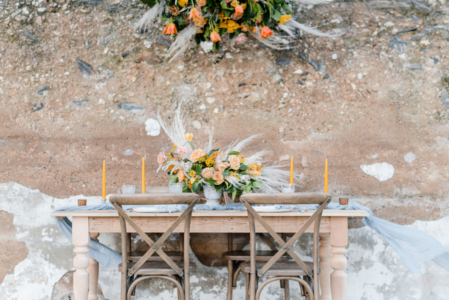 Mustard and orange head table with pampas grass, garden roses and orchids