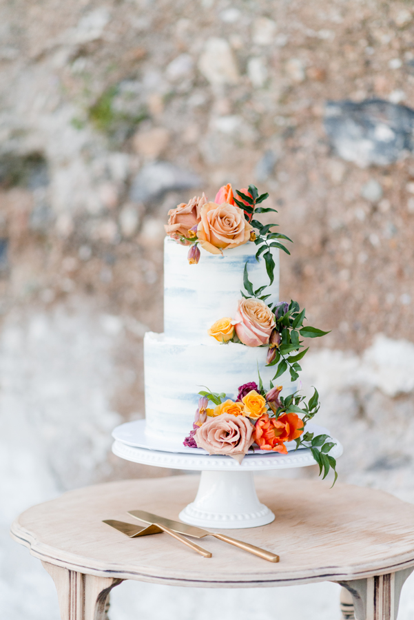 Coral and orange cake flowers with garden roses, orchids and jasmine vines