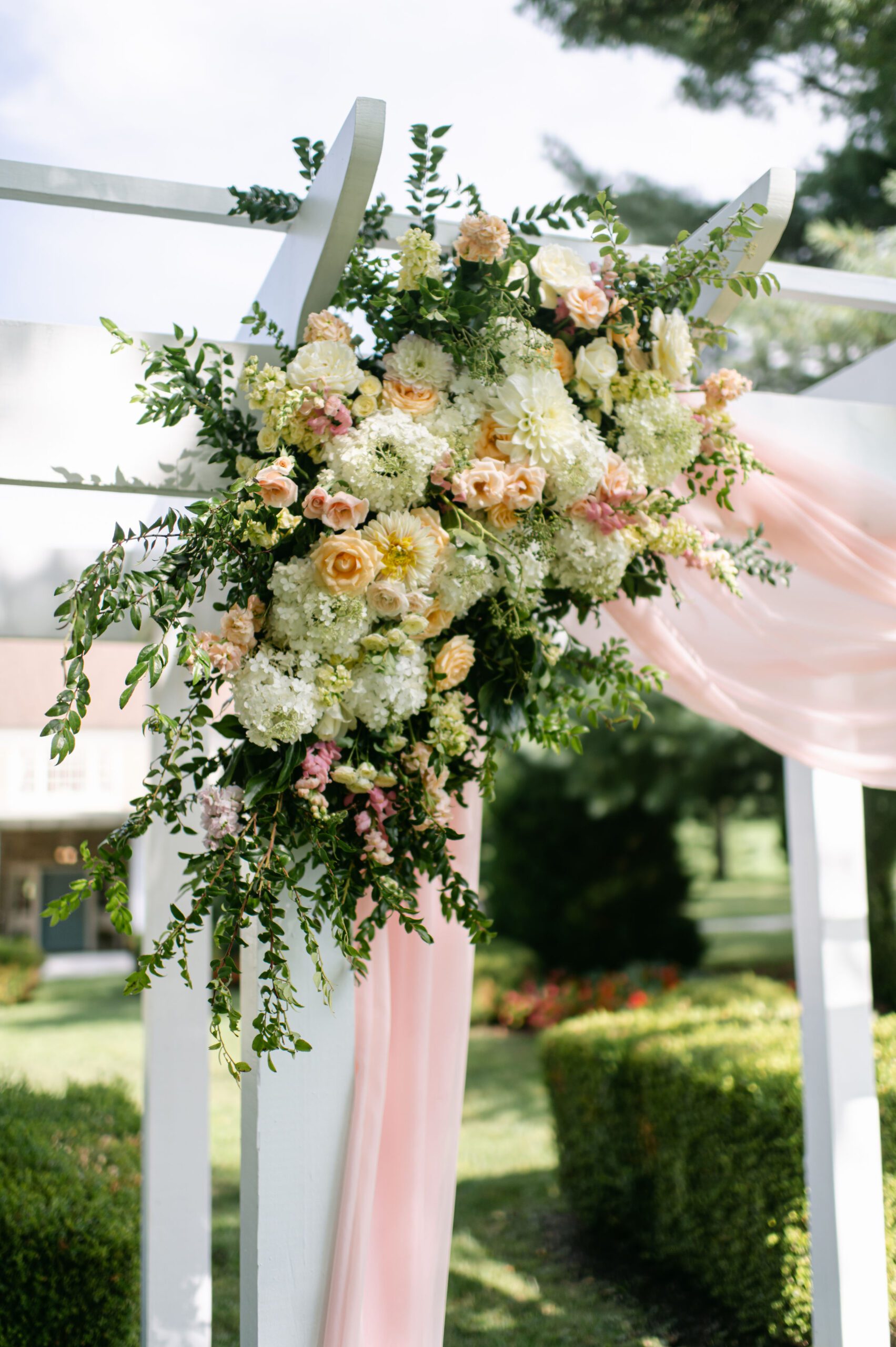 blush and ivory ceremony flowers with blush fabric swag